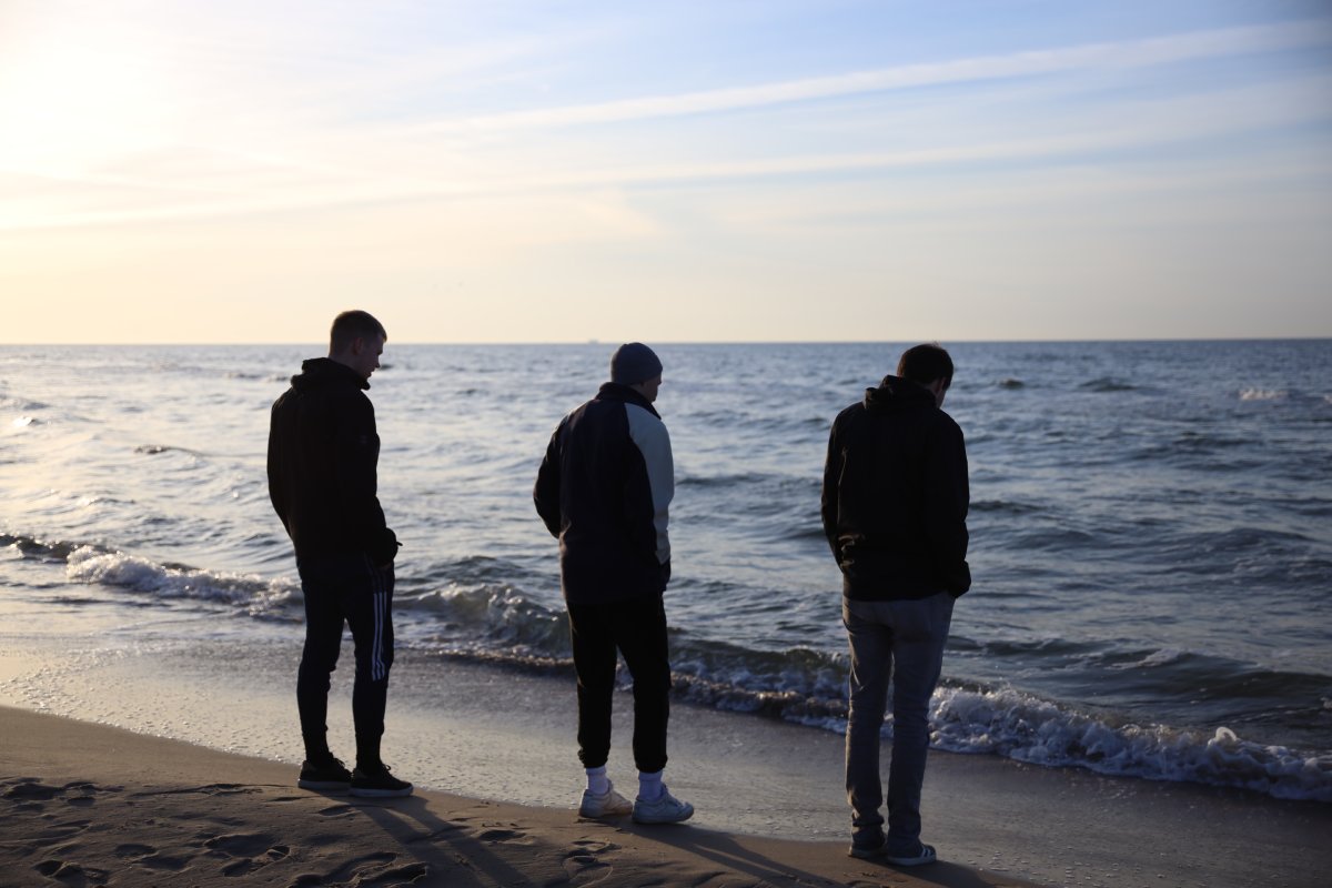 Simon and his brothers at the beach, emphasizing connection